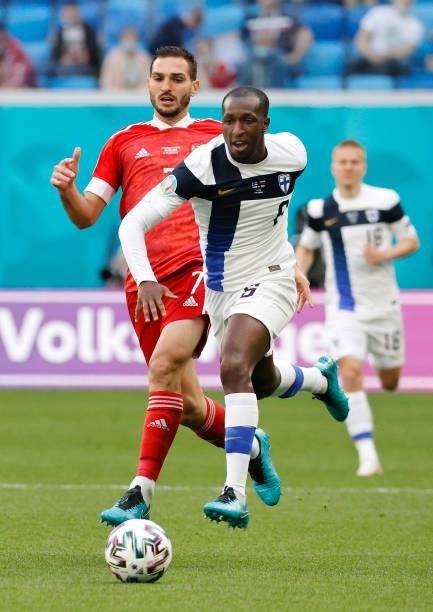 Glen Kamara of Finland runs with the ball whilst under pressure from Magomed Ozdoev of Russia during the UEFA Euro 2020 Championship Group B match...