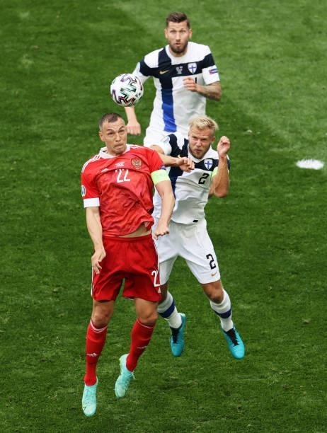 Artem Dzyuba of Russia battles for a header with Paulus Arajuuri of Finland during the UEFA Euro 2020 Championship Group B match between Finland and...