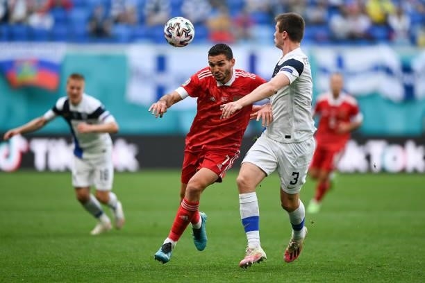 Magomed Ozdoev of Russia battles for possession with Daniel O'Shaughnessy of Finland during the UEFA Euro 2020 Championship Group B match between...