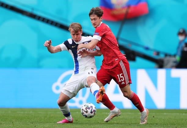 Rasmus Schueller of Finland is challenged by Aleksei Miranchuk of Russia during the UEFA Euro 2020 Championship Group B match between Finland and...