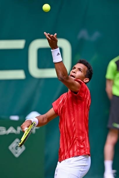 Felix Auger-Aliassime of Canada serves in his match against Roger Federer of Switzerland during day 5 of the Noventi Open at OWL-Arena on June 16,...
