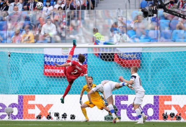 Mario Fernandes of Russia jumps for the ball before picking up an injury and being stretchered off during the UEFA Euro 2020 Championship Group B...