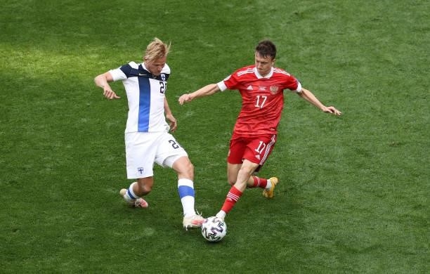 Joel Pohjanpalo of Finland battles for possession with Aleksandr Golovin of Russia during the UEFA Euro 2020 Championship Group B match between...
