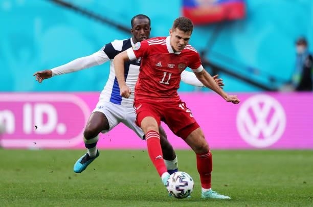 Roman Zobnin of Russia makes a pass whilst under pressure from Glen Kamara of Finland during the UEFA Euro 2020 Championship Group B match between...