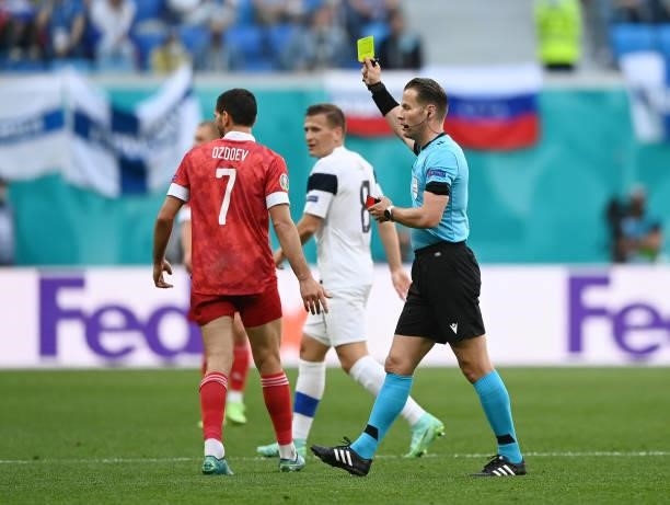 Magomed Ozdoev of Russia is shown a yellow card by Match Referee, Danny Makkelie during the UEFA Euro 2020 Championship Group B match between Finland...