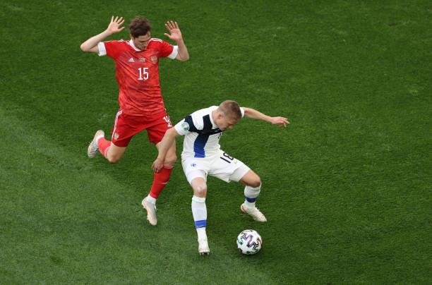 Jere Uronen of Finland shields the ball from Aleksei Miranchuk of Russia during the UEFA Euro 2020 Championship Group B match between Finland and...