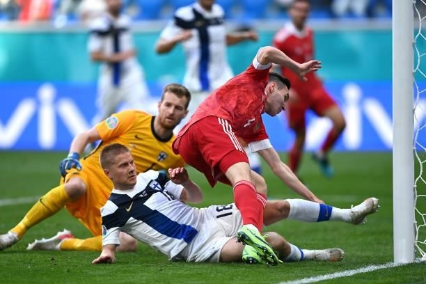 Vyacheslav Karavaev of Russia and Jere Uronen of Finland collide with the goal post during the UEFA Euro 2020 Championship Group B match between...