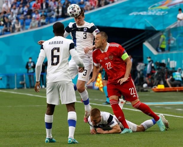 Daniel O'Shaughnessy of Finland competes for a header with Artem Dzyuba of Russia during the UEFA Euro 2020 Championship Group B match between...