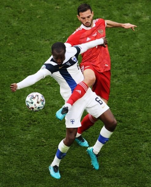 Glen Kamara of Finland is challenged by Magomed Ozdoev of Russia during the UEFA Euro 2020 Championship Group B match between Finland and Russia at...