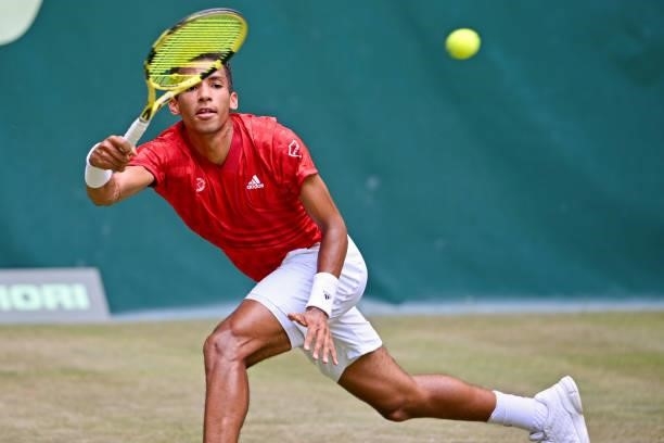 Felix Auger-Aliassime of Canada plays a forehand in his match against Roger Federer of Switzerland during day 5 of the Noventi Open at OWL-Arena on...