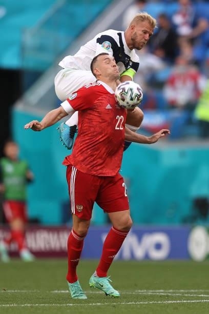 Paulus Arajuuri of Finland battles for possession with Artem Dzyuba of Russia during the UEFA Euro 2020 Championship Group B match between Finland...