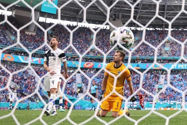 Lukas Hradecky and Joona Toivio of Finland look dejected after Russia's first goal scored by Aleksei Miranchuk during the UEFA Euro 2020 Championship...