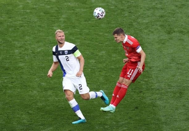 Roman Zobnin of Russia heads the ball whilst under pressure from Paulus Arajuuri of Finland during the UEFA Euro 2020 Championship Group B match...