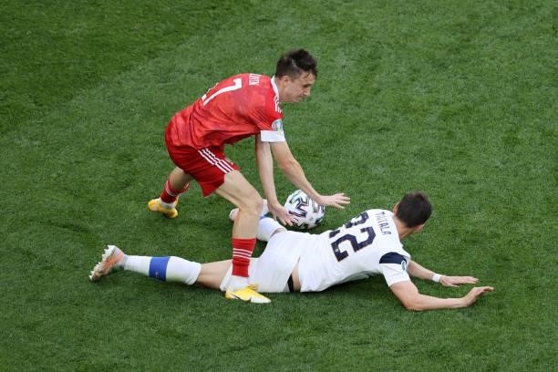 Aleksandr Golovin of Russia battles for possession with Jukka Raitala of Finland during the UEFA Euro 2020 Championship Group B match between Finland...