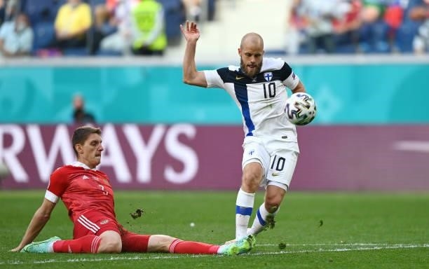 Teemu Pukki of Finland is challenged by Igor Diveev of Russia during the UEFA Euro 2020 Championship Group B match between Finland and Russia at...