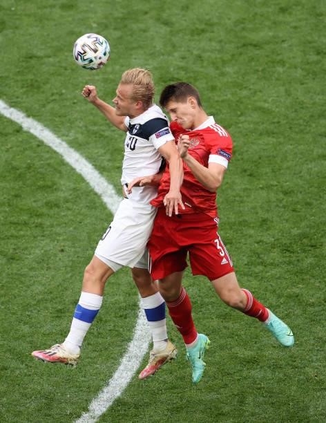 Joel Pohjanpalo of Finland battles for a header with Igor Diveev of Russia during the UEFA Euro 2020 Championship Group B match between Finland and...