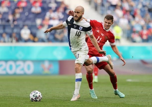 Teemu Pukki of Finland is challenged by Roman Zobnin of Russia during the UEFA Euro 2020 Championship Group B match between Finland and Russia at...