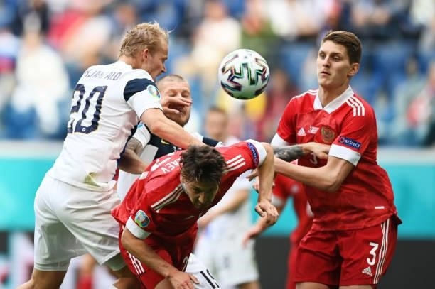 Daler Kuzyaev of Russia battles for possession with Joel Pohjanpalo of Finland as Igor Diveev of Russia looks on during the UEFA Euro 2020...