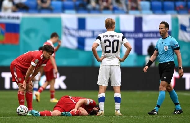 Georgi Dzhikiya of Russia reacts as he appears to be injured during the UEFA Euro 2020 Championship Group B match between Finland and Russia at Saint...