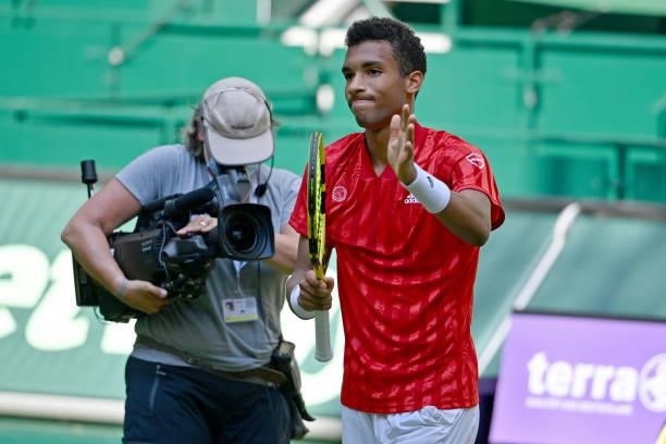 Felix Auger-Aliassime of Canada celebrates after winning his match against Roger Federer of Switzerland during day 5 of the Noventi Open at OWL-Arena...
