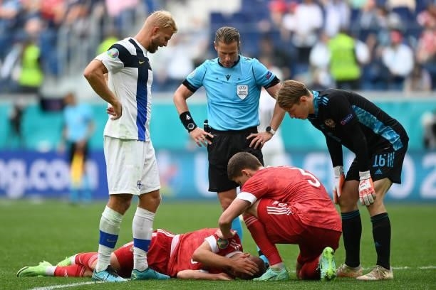 Dmitri Barinov of Russia goes down injured during the UEFA Euro 2020 Championship Group B match between Finland and Russia at Saint Petersburg...