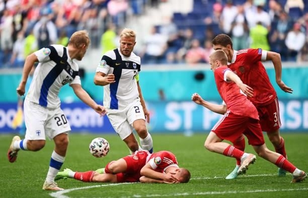 Dmitri Barinov of Russia goes down injured as Paulus Arajuuri of Finland looks to play on during the UEFA Euro 2020 Championship Group B match...
