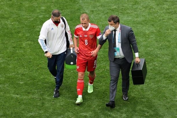 Dmitri Barinov of Russia leaves the pitch after picking up an injury during the UEFA Euro 2020 Championship Group B match between Finland and Russia...