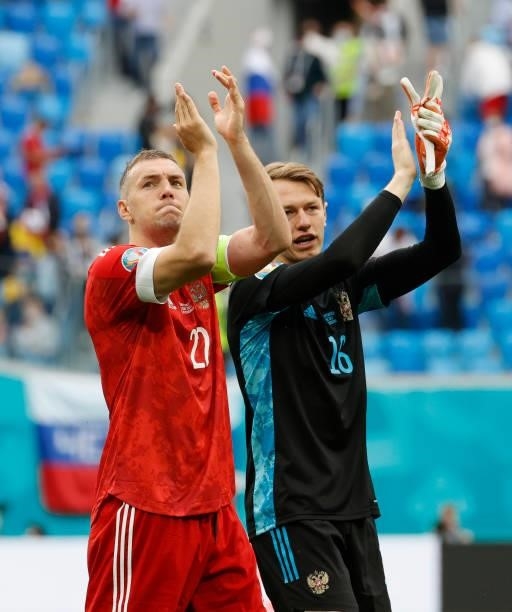 Artem Dzyuba and Matvei Safonov of Russia applaud the fans following victory in the UEFA Euro 2020 Championship Group B match between Finland and...