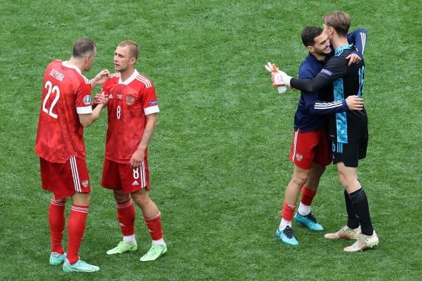 Artem Dzyuba of Russia interacts with team mate Dmitri Barinov after the UEFA Euro 2020 Championship Group B match between Finland and Russia at...