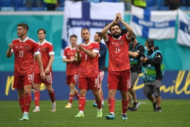 Rifat Zhemaletdinov, Dmitri Barinov and Georgi Dzhikiya of Russia applauds the fans after the UEFA Euro 2020 Championship Group B match between...