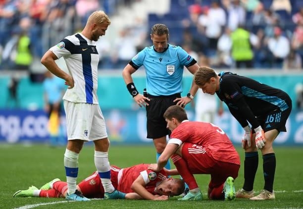 Dmitri Barinov of Russia reacts as he appears to be injured during the UEFA Euro 2020 Championship Group B match between Finland and Russia at Saint...