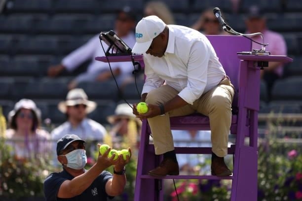 Chair umpire Carlos Bernardes from Brazil changes balls during Day 3 of The cinch Championships at The Queen's Club on June 16, 2021 in London,...
