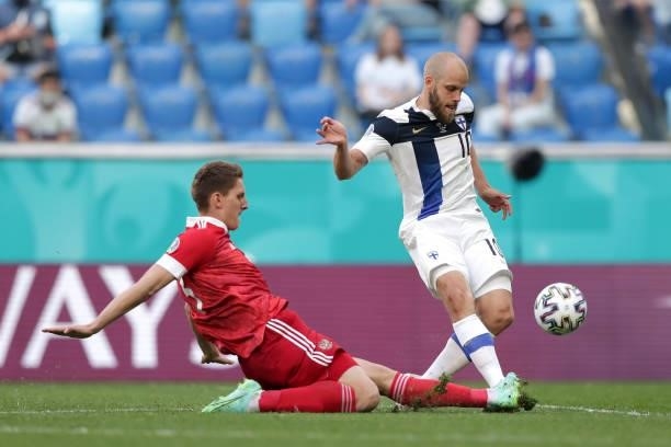 Teemu Pukki of Finland is challenged by Andrei Semenov of Russia during the UEFA Euro 2020 Championship Group B match between Finland and Russia at...