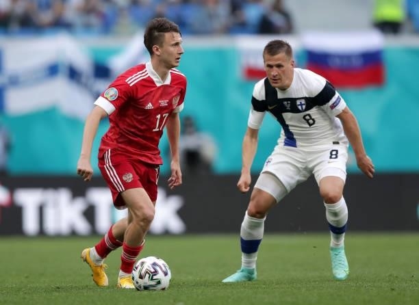Aleksandr Golovin of Russia is closed down by Robin Lod of Finland during the UEFA Euro 2020 Championship Group B match between Finland and Russia at...