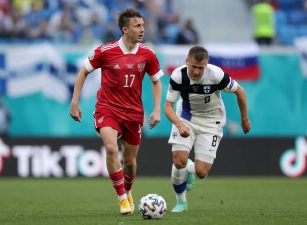 Aleksandr Golovin of Russia runs with the ball whilst under pressure from Robin Lod of Finland during the UEFA Euro 2020 Championship Group B match...