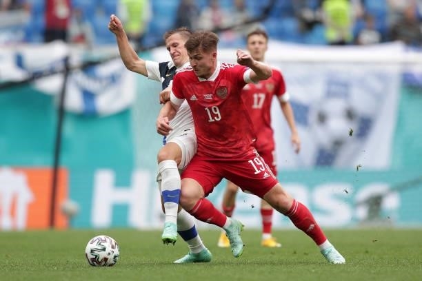 Robin Lod of Finland battles for possession with Rifat Zhemaletdinov of Russia during the UEFA Euro 2020 Championship Group B match between Finland...