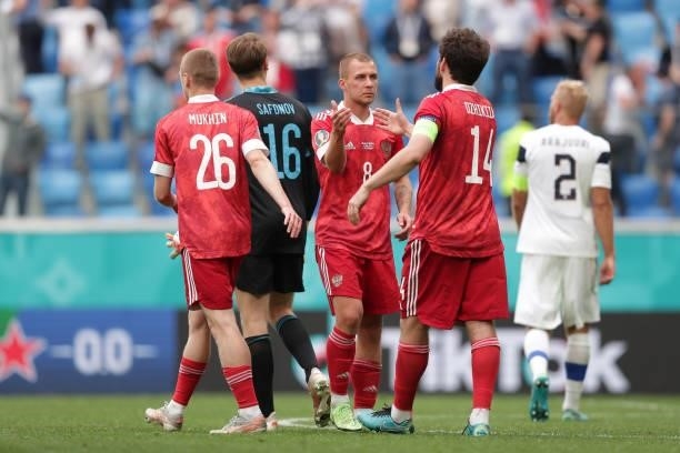 Dmitri Barinov of Russia shakes hands with Georgi Dzhikiya following victory in the UEFA Euro 2020 Championship Group B match between Finland and...