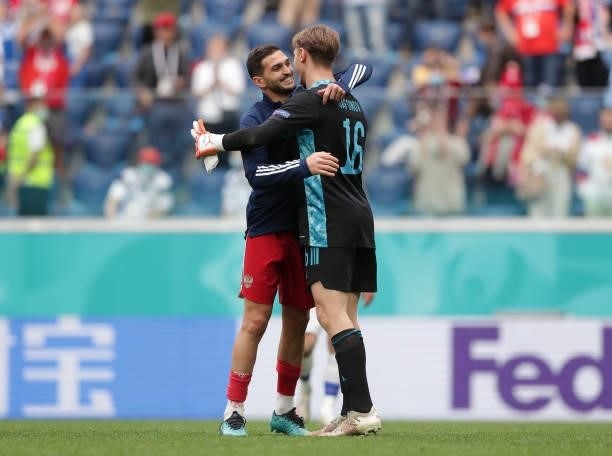 Matvei Safonov of Russia celebrates with team mate Magomed Ozdoev after victory in the UEFA Euro 2020 Championship Group B match between Finland and...