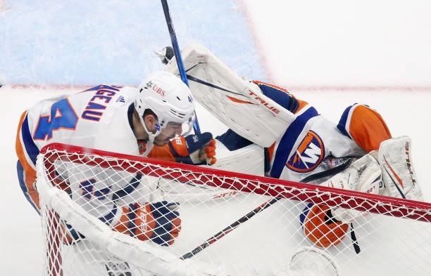 Brayden Point of the Tampa Bay Lightning collides with Semyon Varlamov of the New York Islanders in the net during the first period in Game Two of...