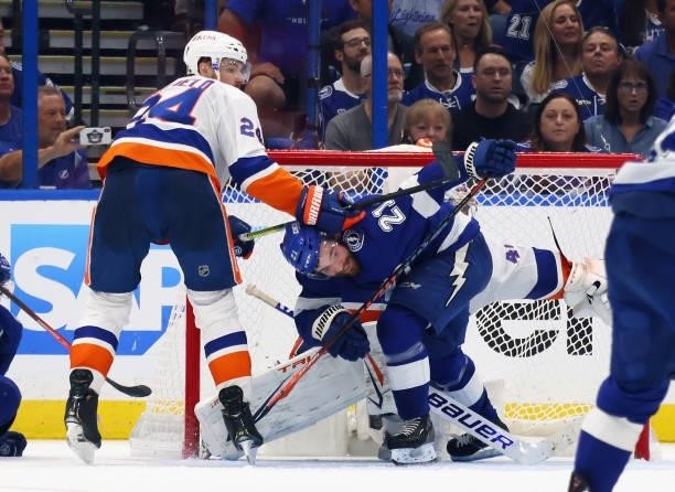 Scott Mayfield of the New York Islanders checks Brayden Point of the Tampa Bay Lightning in Game Two of the Stanley Cup Semifinals during the 2021...