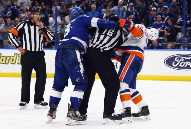 Mikhail Sergachev of the Tampa Bay Lightning takes a punch at Cal Clutterbuck of the New York Islanders in Game Two of the Stanley Cup Semifinals...