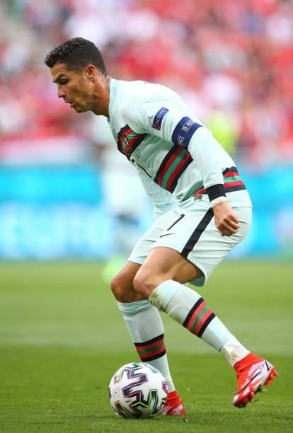 Cristiano Ronaldo of Portugal runs with the ball during the UEFA Euro 2020 Championship Group F match between Hungary and Portugal on June 15, 2021...
