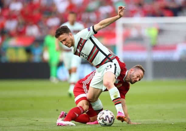 Diogo Jota of Portugal battles for possession with Gergo Lovrencsics of Hungary during the UEFA Euro 2020 Championship Group F match between Hungary...