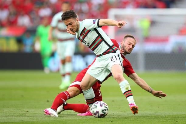 Diogo Jota of Portugal battles for possession with Gergo Lovrencsics of Hungary during the UEFA Euro 2020 Championship Group F match between Hungary...