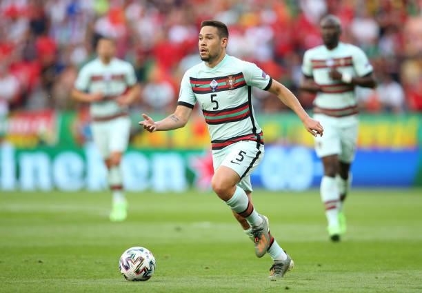 Raphael Guerreiro of Portugal runs with the ball during the UEFA Euro 2020 Championship Group F match between Hungary and Portugal on June 15, 2021...