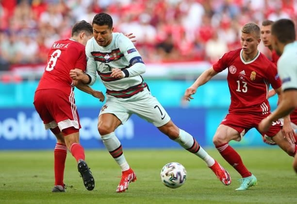 Cristiano Ronaldo of Portugal runs in to Adam Nagy of Hungary during the UEFA Euro 2020 Championship Group F match between Hungary and Portugal on...