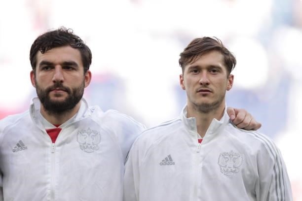 Aleksei Miranchuk of Russia and his teammate Georgi Dzhikiya sing their national anthem prior to start the UEFA Euro 2020 Championship Group B match...