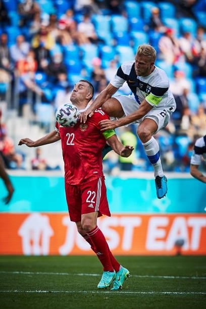 Artem Dzyuba of Russia competes with Paulus Arajuuri of Finland during the UEFA Euro 2020 Championship Group B match between Finland and Russia at...