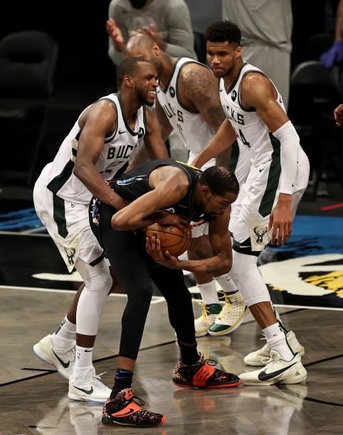 Khris Middleton of the Milwaukee Bucks fouls Kevin Durant of the Brooklyn Nets in the fourth quarter during game 5 of the Eastern Conference second...