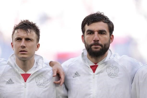 Aleksandr Golovin of Russia and his teammate Georgi Dzhikiya sign their national anthem prior to start the UEFA Euro 2020 Championship Group B match...